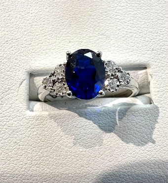 10k white gold created sapphire ring

1 Created ruby 6x8mm
0.10tcw diamonds.