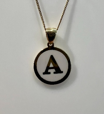 10K gold; disc initial with white enamel and chain.