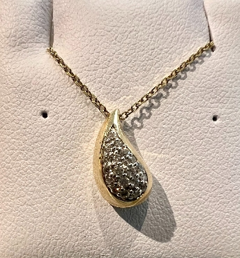 10K yellow gold diamond drop pendant.
Total diamond weight:.04 carat