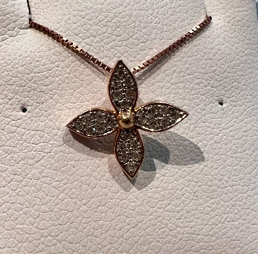 10k rose gold; diamond flower pendant with chain.
Total diamond weight: 0.10 carat